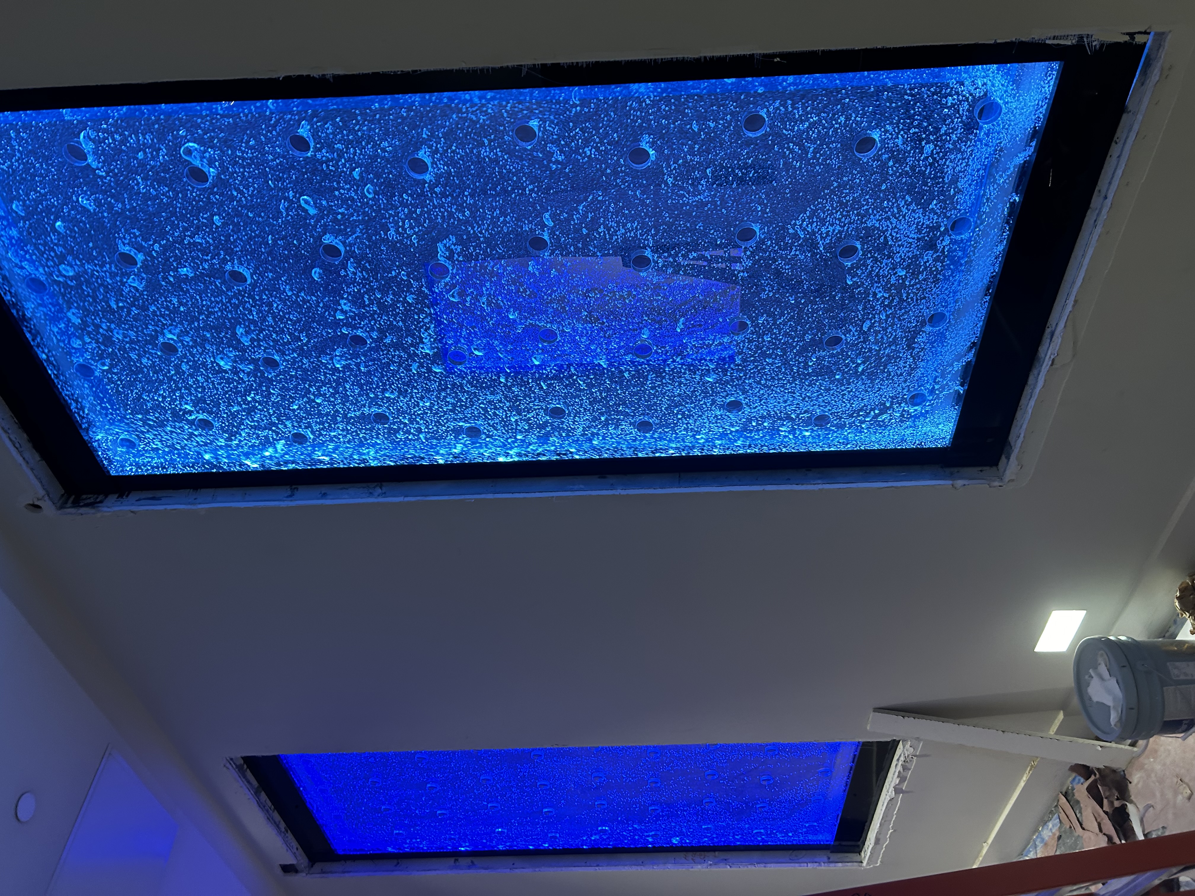Contemporary bubble wall water feature with lighting in a hotel lobby