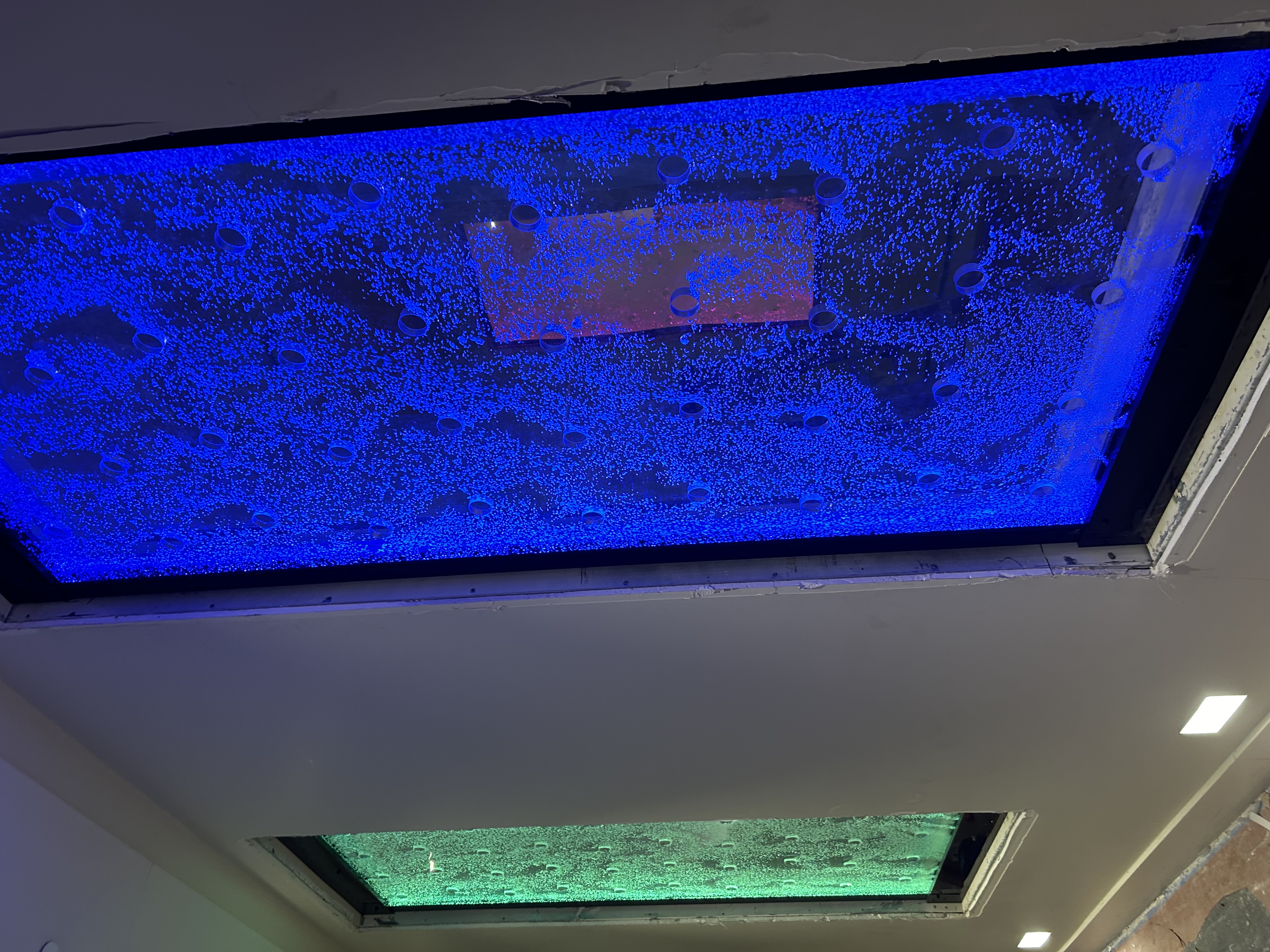 LED-lit bubble wall installation in a stylish lounge area